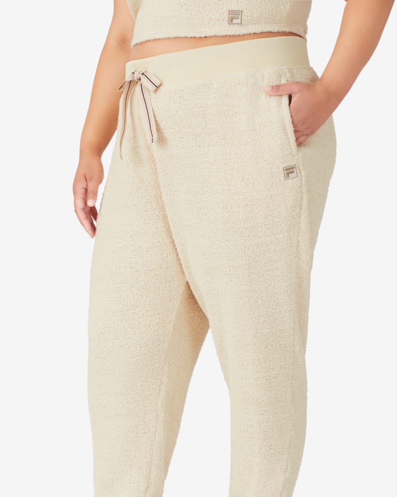 Front of a model wearing a size 1X Cheri Homey Jogger in Bleached Sand by FILA. | dia_product_style_image_id:252648